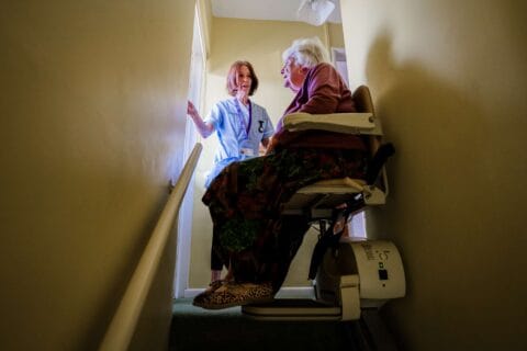 DACCS personal carer with a client on the stairs in Tavistock