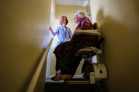 DACCS personal carer with a client on the stairs in Tavistock