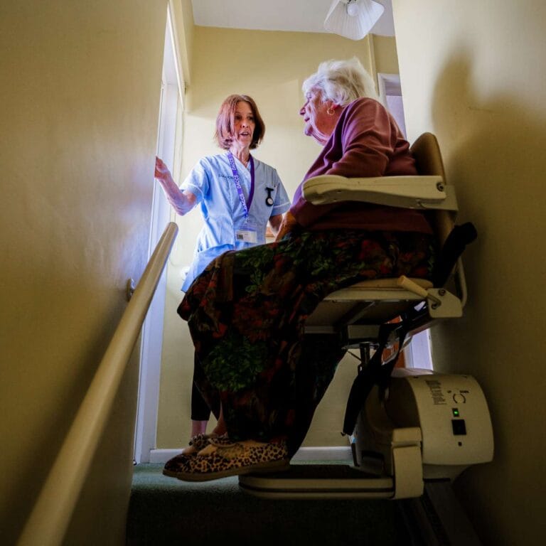 DACCS personal carer with a client on the stairs in Tavistock