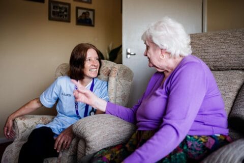 DACCS personal carer with a client in their lounge in Tavistock